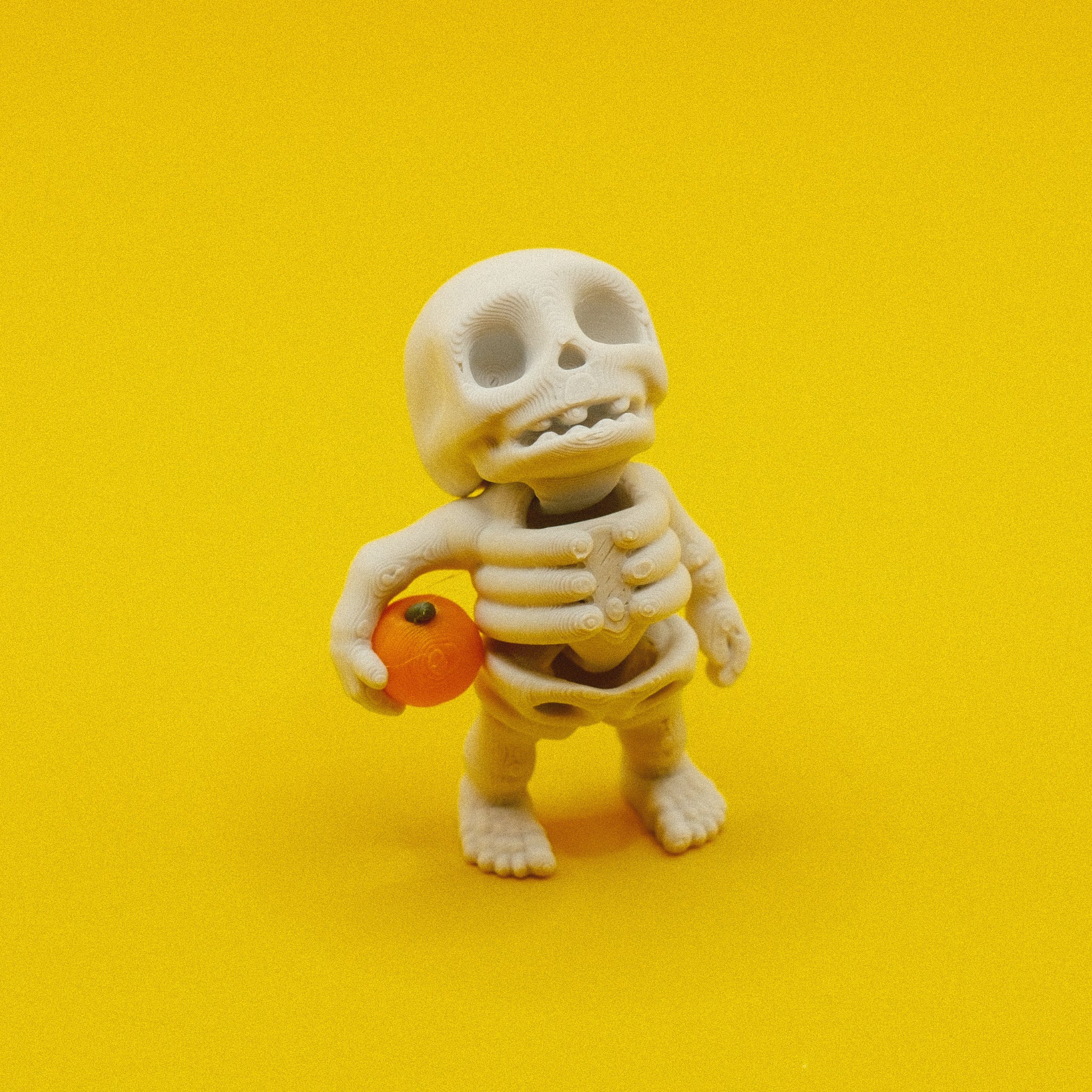 Skeleton Holding Pumpkin